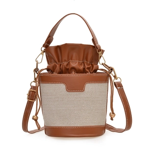 Retro stylish two-tone bucket bag with brown leather and beige canvas textures