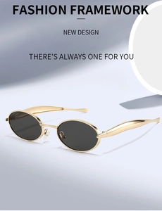 Detailed view of oval metal sunglasses with thick gold frames and dark lenses