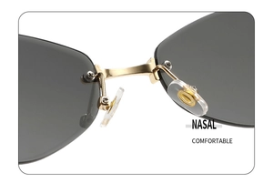 Detail of golden metal bridge and comfortable silicone nose pads on rimless sunglasses