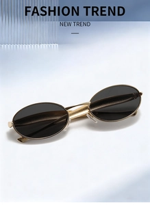 Detailed macro view of vintage gold metal frames and dark lenses with silicone nose pads