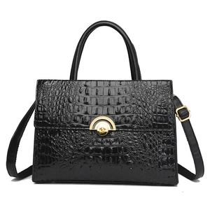 Elegant black crocodile embossed faux leather handbag with geometric gold buckle and strap
