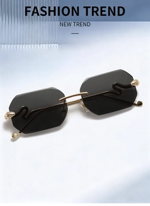 Detail of gold metal S-shaped wavy temple and rimless dark gray geometric lenses