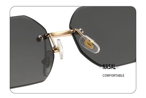 Macro detail of golden metal bridge and soft silicone nose pads on rimless sunglasses
