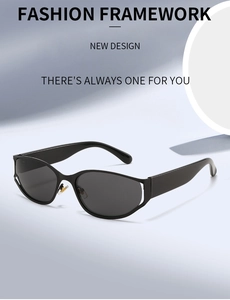 Detail of trendy oval black sunglasses with thick frames and dark lenses in minimalist style