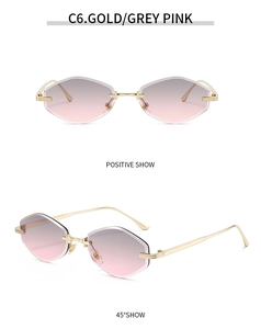 Detail of rimless polygon sunglasses with gold metal frame and grey pink gradient lenses