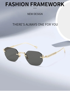 Détail de lunettes de soleil octogonales sans monture avec branches dorées et verres gris