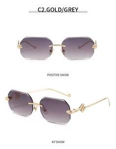 Detail of rimless sunglasses featuring gradient grey lenses and 3D snake-shaped gold temples