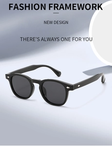 Detail of retro round sunglasses with silver arrow rivets on black acetate frame