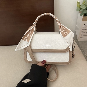 Chic beige and brown crossbody bag with lychee texture and silk scarf handle detail