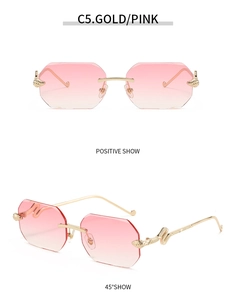 Detail of rimless octagonal sunglasses with gold snake metal relief and pink gradient lenses