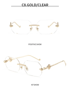 Detail of rimless octagonal sunglasses featuring golden snake-shaped carved metal temples