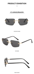 Detailed close-up of rimless sunglasses with gold metal hinges and dark grey lenses
