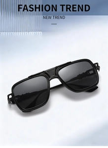 Detail of black aviator sunglasses showing industrial hinge design and textured temples