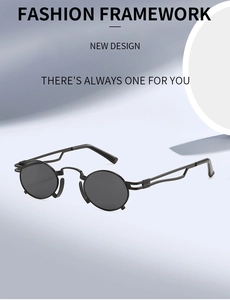 Close-up of vintage steampunk round sunglasses with hollowed-out matte black metal temples