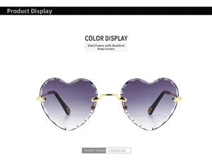 Detail of rimless heart sunglasses with scalloped cut edges and gradient grey lenses