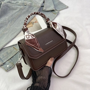 Brown litchi leather crossbody bag with scarf-wrapped handle and fashion logo