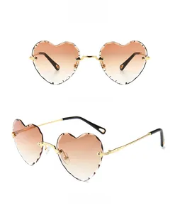 Detail of gradient brown heart-shaped sunglasses with stylish metal cut edges