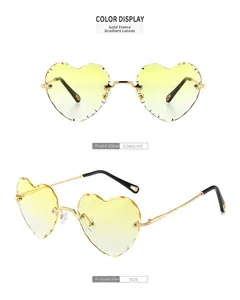 Close-up of heart-shaped rimless sunglasses with gradient yellow lenses and gold metal temples