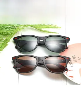 Top view of matte black polarized sunglasses with grey and brown lenses on a white table