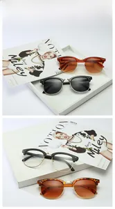 Detailed view of vintage half-frame sunglasses with tortoise and black metal frames
