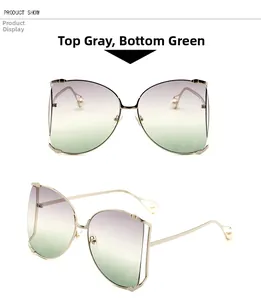 Détail des lunettes papillon avec verres dégradés gris-vert et ornements en perles fines