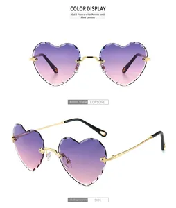 Detail view of heart-shaped rimless sunglasses with purple-pink gradient lenses