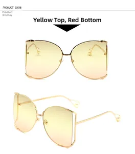 Détail de lunettes de soleil papillon sans monture avec verres dégradés jaune-rouge et perles