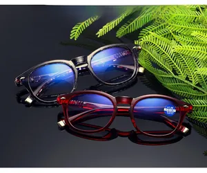 Detail of tortoise and burgundy bifocal reading glasses with metal temple accents