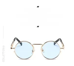 Detail of round light blue lenses and gold metal frame with retro steampunk accents