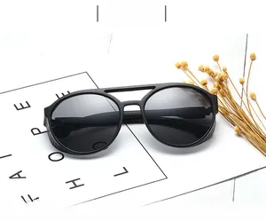 Steampunk round sunglasses with thick black frames and mesh side shields on a white base