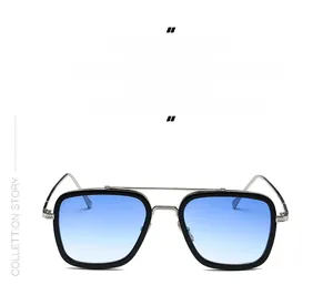 Detail of pilot sunglasses with blue-purple gradient lenses and silver metal double bridge