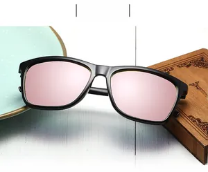 Detail of square polarized sunglasses featuring purple mirrored lenses and black matte frames