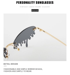 Detail of vintage large-frame sunglasses with unique gold drip design and grey lenses