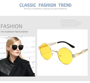 Detail of steampunk sunglasses with gold metal spring temples and round yellow lenses