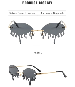Detail of tear-shaped melting sunglasses with golden metal frame and black ash lenses