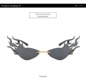 Detailed front view of gold-rimmed flame shaped rimless sunglasses with black glass lenses