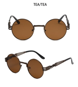 Close-up of steampunk round sunglasses featuring intricate metal carvings and tea lenses