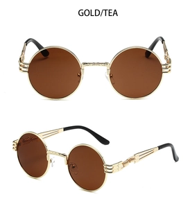 Detailed macro view of gold steampunk sunglasses with intricate engraved metal temples