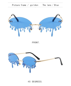 Macro view of gold metal frames and blue melting tear-shaped lenses on trendy sunglasses