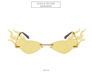 Detailed front view of gold and yellow flame-shaped rimless sunglasses with metal nose pads