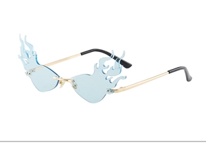 Close-up of flame-shaped rimless sunglasses with light blue lenses and gold metal temples