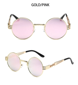 Close-up of steampunk gold metal frame sunglasses with pink gradient round lenses