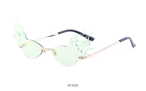 Detail shot of flame-shaped rimless sunglasses with light green lenses and gold metal frame