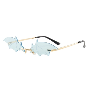 Unique blue bat wing sunglasses with gold metal frame and rimless oversized design