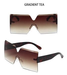 Close-up of oversized rimless square sunglasses with gradient tea lenses and tortoise temples