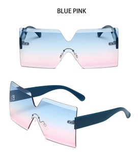 Close-up of oversized rimless sunglasses featuring blue pink gradient lenses and V-shape notch
