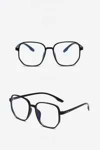 Detail view of bright black polygon TR90 glasses frames with blue light blocking lenses