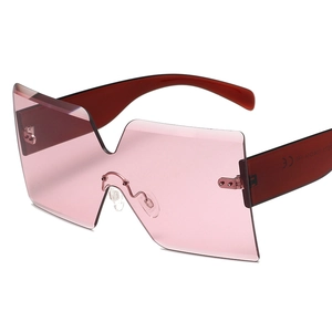 Oversized rimless sunglasses with pink gradient lenses and deep red temples