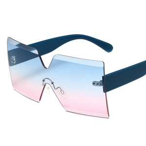 Frameless oversized sunglasses featuring blue pink gradient lens and matte blue temple