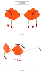Cloud-shaped orange sunglasses with golden chains and red teardrop charms detail
